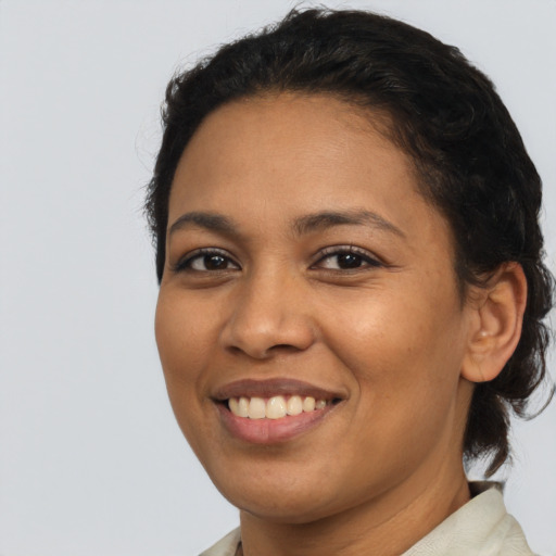 Joyful latino young-adult female with short  brown hair and brown eyes