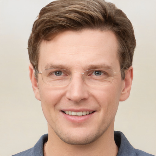 Joyful white adult male with short  brown hair and grey eyes