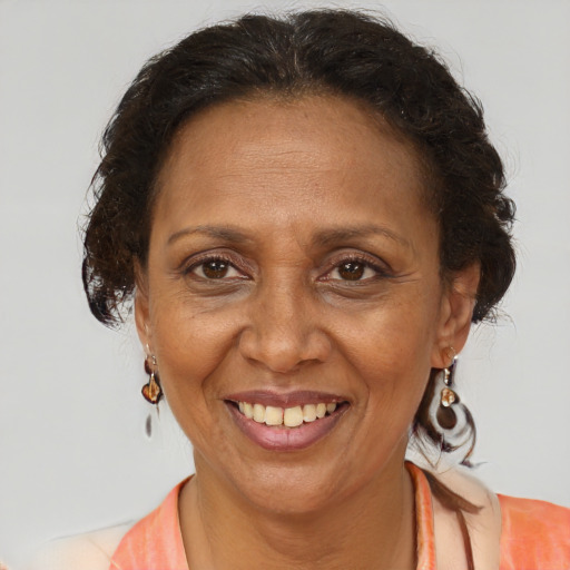 Joyful black adult female with medium  brown hair and brown eyes