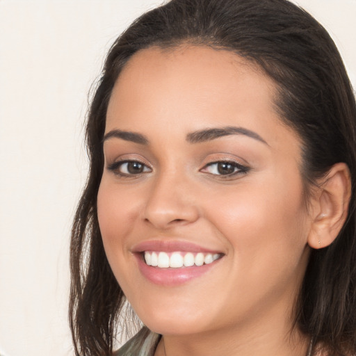 Joyful white young-adult female with long  brown hair and brown eyes