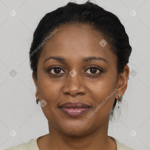 Joyful black adult female with short  black hair and brown eyes