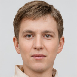 Joyful white young-adult male with short  brown hair and grey eyes