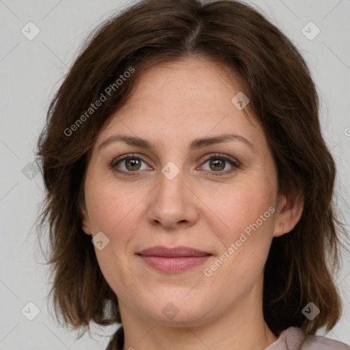 Joyful white adult female with medium  brown hair and green eyes