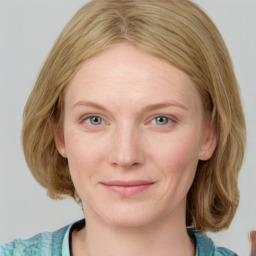 Joyful white young-adult female with medium  brown hair and blue eyes