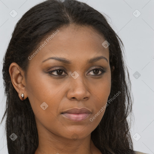 Joyful black young-adult female with long  brown hair and brown eyes