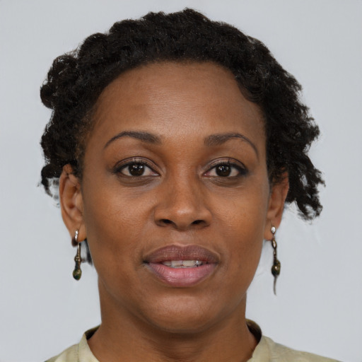 Joyful black adult female with short  brown hair and brown eyes
