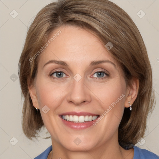 Joyful white adult female with medium  brown hair and blue eyes