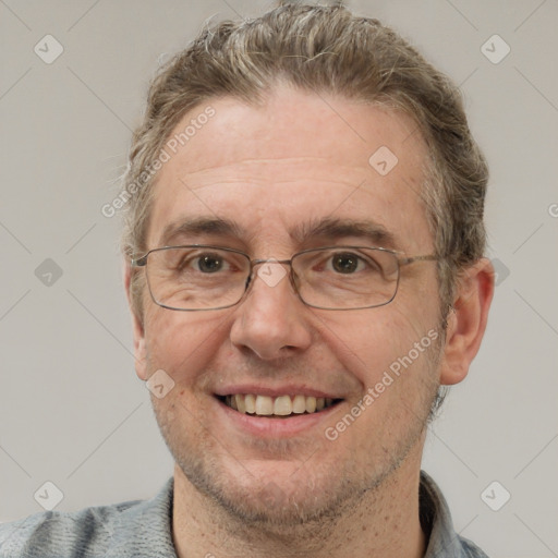 Joyful white middle-aged male with short  brown hair and grey eyes