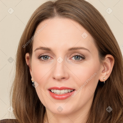 Joyful white adult female with long  brown hair and grey eyes