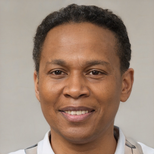 Joyful latino adult male with short  brown hair and brown eyes