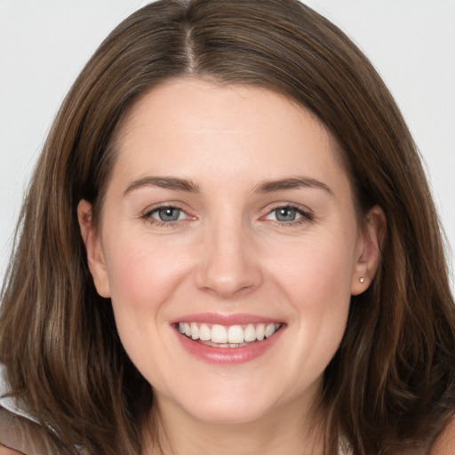 Joyful white young-adult female with long  brown hair and grey eyes