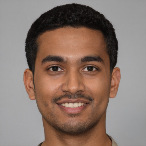 Joyful latino young-adult male with short  black hair and brown eyes