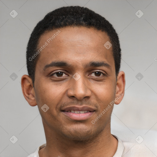 Joyful black young-adult male with short  brown hair and brown eyes