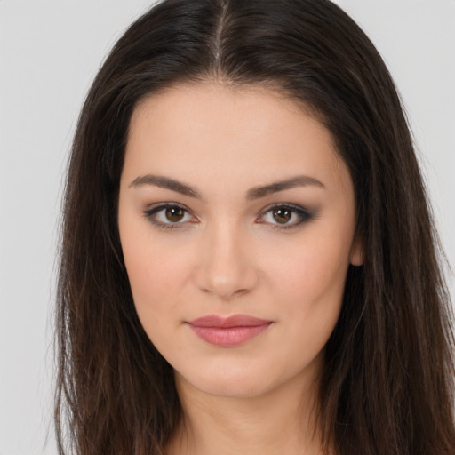 Joyful white young-adult female with long  brown hair and brown eyes