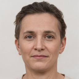 Joyful white adult female with short  brown hair and grey eyes