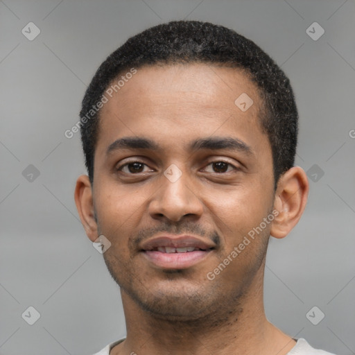 Joyful black young-adult male with short  black hair and brown eyes