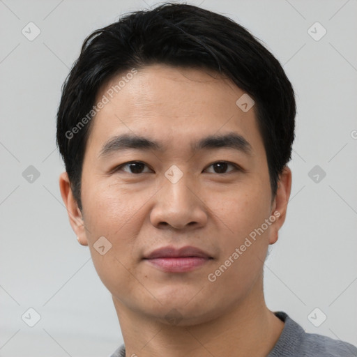 Joyful asian young-adult male with short  black hair and brown eyes