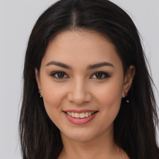 Joyful white young-adult female with long  brown hair and brown eyes