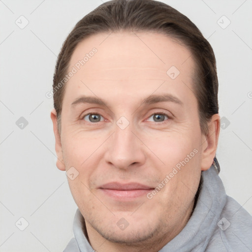 Joyful white adult male with short  brown hair and grey eyes