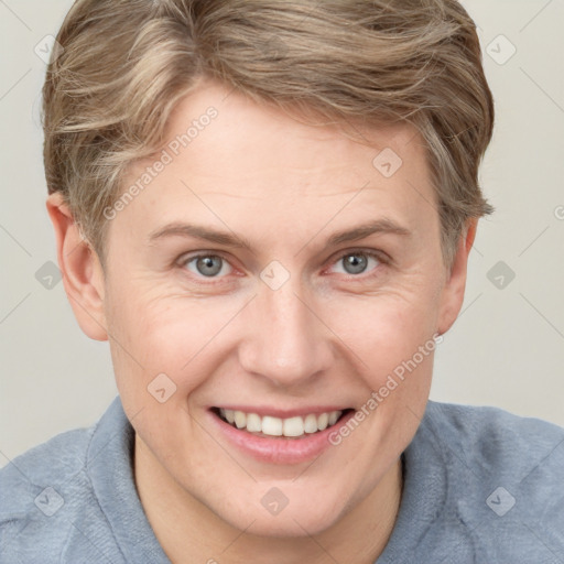 Joyful white adult female with short  brown hair and grey eyes