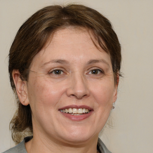 Joyful white adult female with medium  brown hair and brown eyes