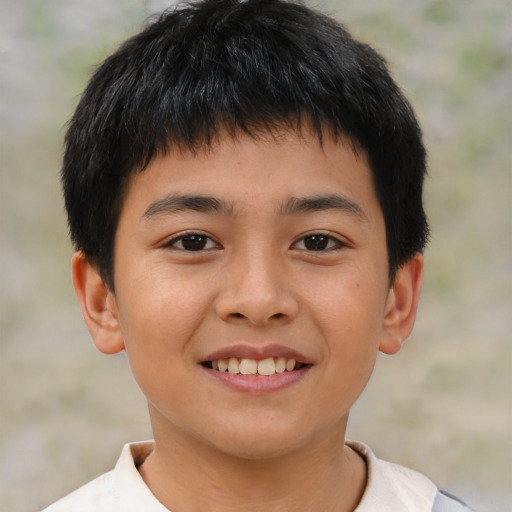 Joyful asian child male with short  brown hair and brown eyes
