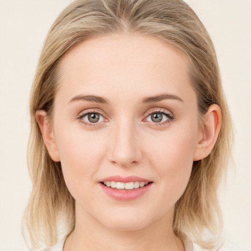 Joyful white young-adult female with medium  brown hair and blue eyes