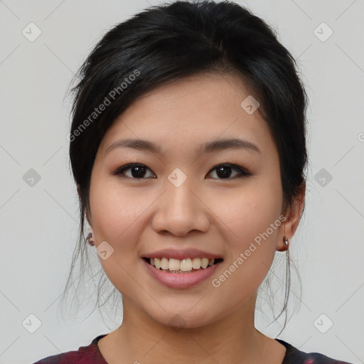 Joyful asian young-adult female with medium  black hair and brown eyes