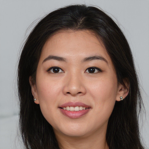 Joyful asian young-adult female with long  brown hair and brown eyes