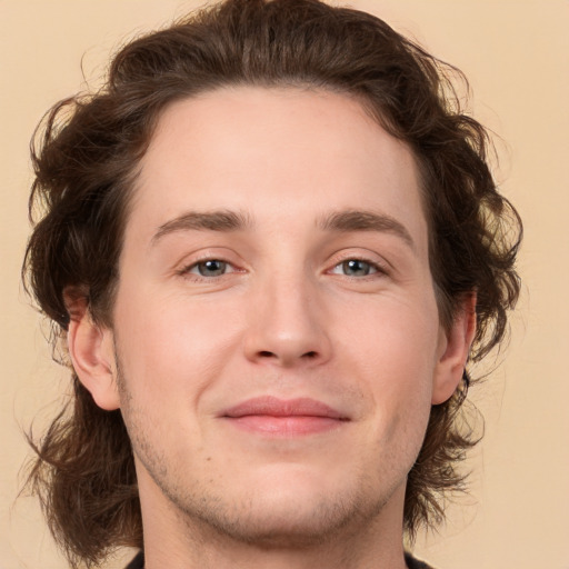 Joyful white young-adult male with medium  brown hair and brown eyes