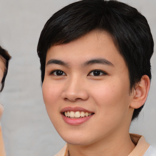 Joyful asian young-adult female with short  brown hair and brown eyes