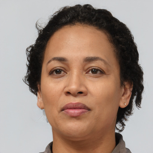 Joyful latino adult female with short  brown hair and brown eyes