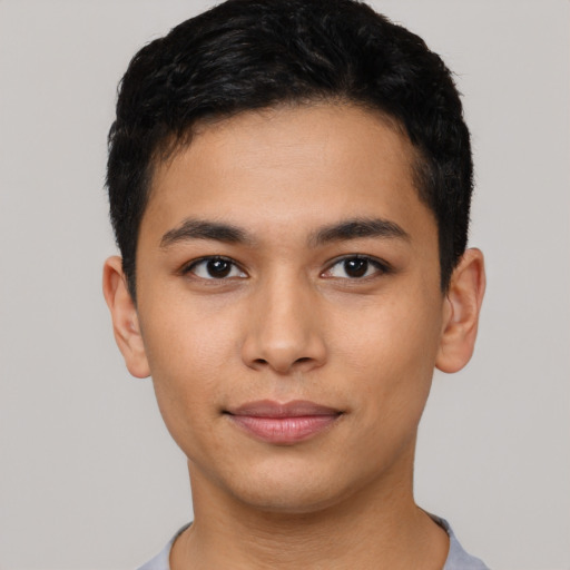 Joyful asian young-adult male with short  black hair and brown eyes