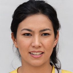 Joyful asian young-adult female with medium  brown hair and brown eyes