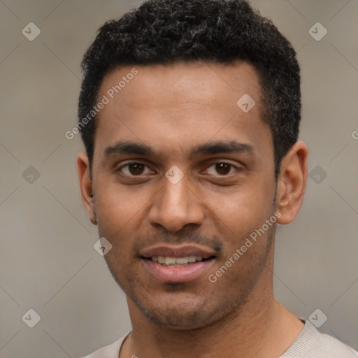 Joyful black young-adult male with short  black hair and brown eyes