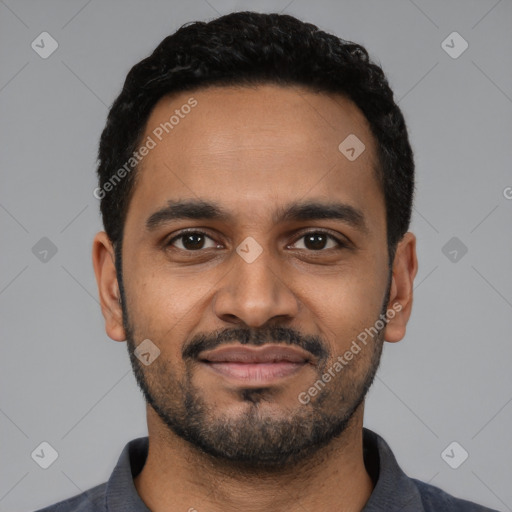 Joyful black young-adult male with short  black hair and brown eyes