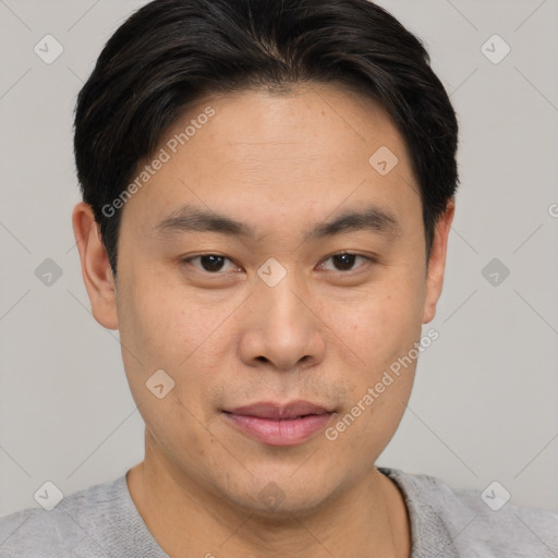 Joyful asian young-adult male with short  brown hair and brown eyes