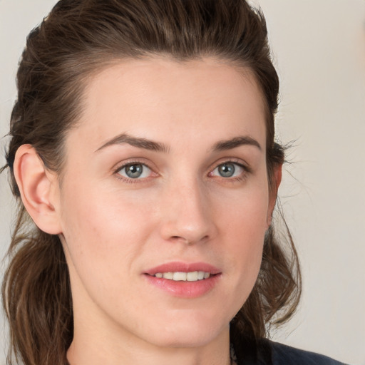 Joyful white young-adult female with medium  brown hair and grey eyes