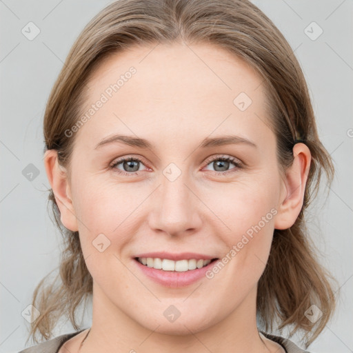 Joyful white young-adult female with medium  brown hair and blue eyes