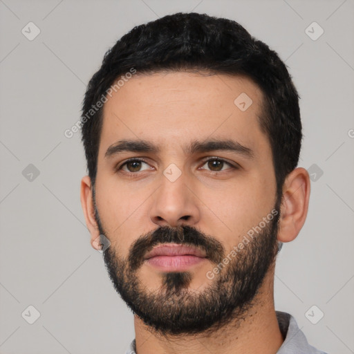 Neutral latino young-adult male with short  black hair and brown eyes