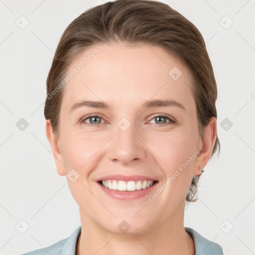 Joyful white young-adult female with short  brown hair and grey eyes