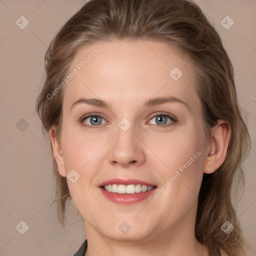 Joyful white young-adult female with long  brown hair and grey eyes