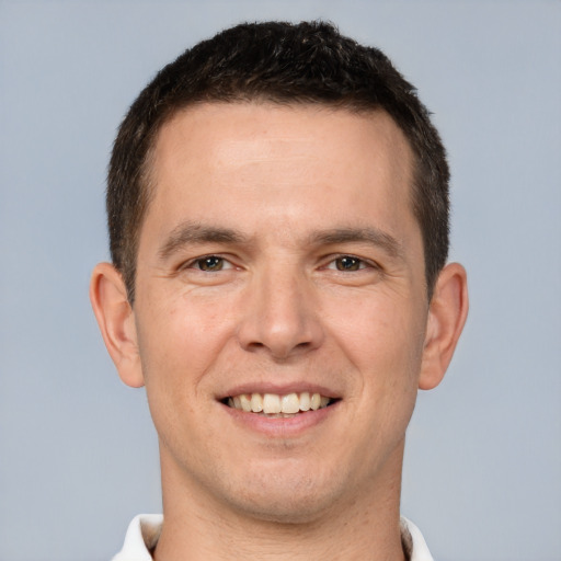 Joyful white young-adult male with short  brown hair and brown eyes