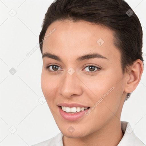 Joyful white young-adult female with short  brown hair and brown eyes