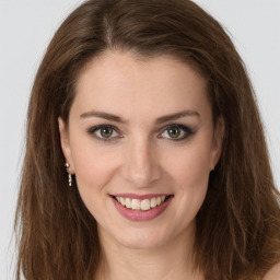 Joyful white young-adult female with long  brown hair and green eyes