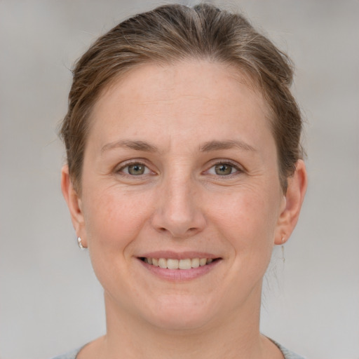 Joyful white adult female with short  brown hair and grey eyes