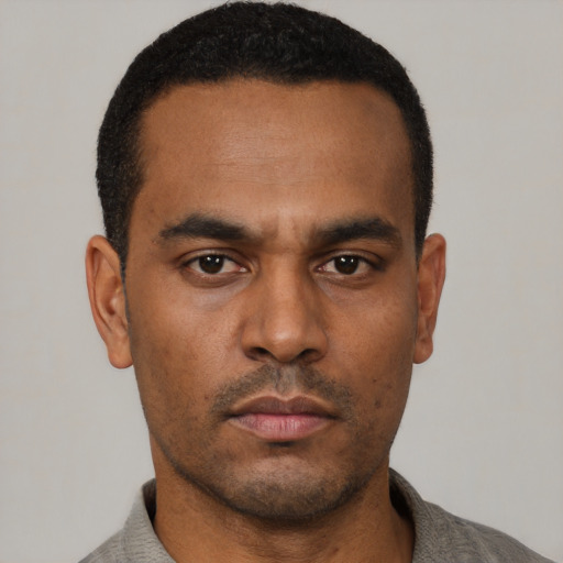 Neutral black young-adult male with short  black hair and brown eyes
