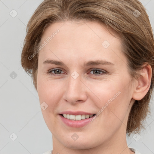 Joyful white young-adult female with medium  brown hair and grey eyes