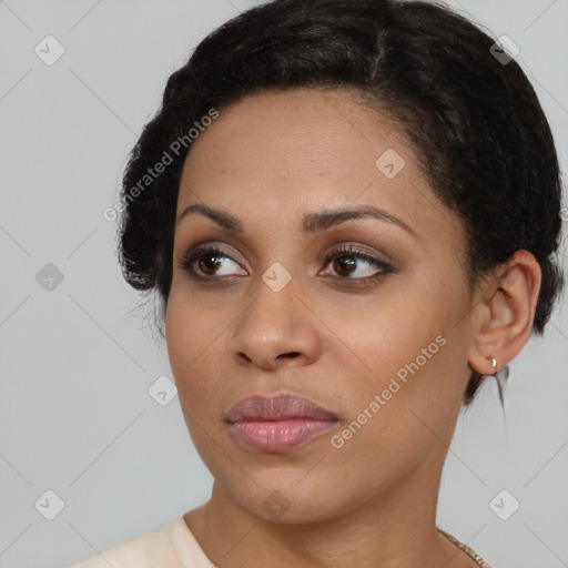 Joyful black young-adult female with short  brown hair and brown eyes