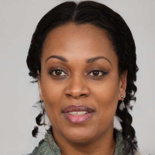 Joyful black adult female with medium  black hair and brown eyes
